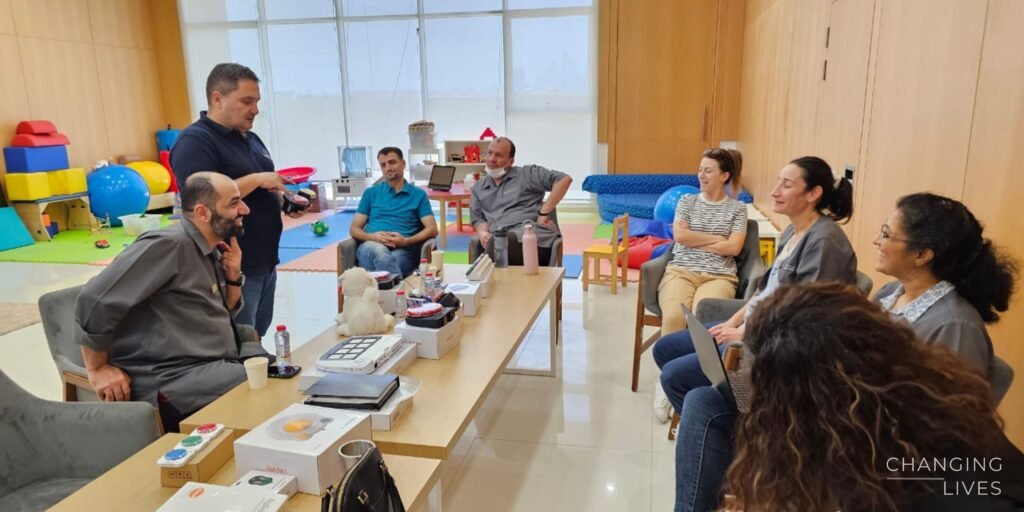 Participants trying assistive technology devices during a training session