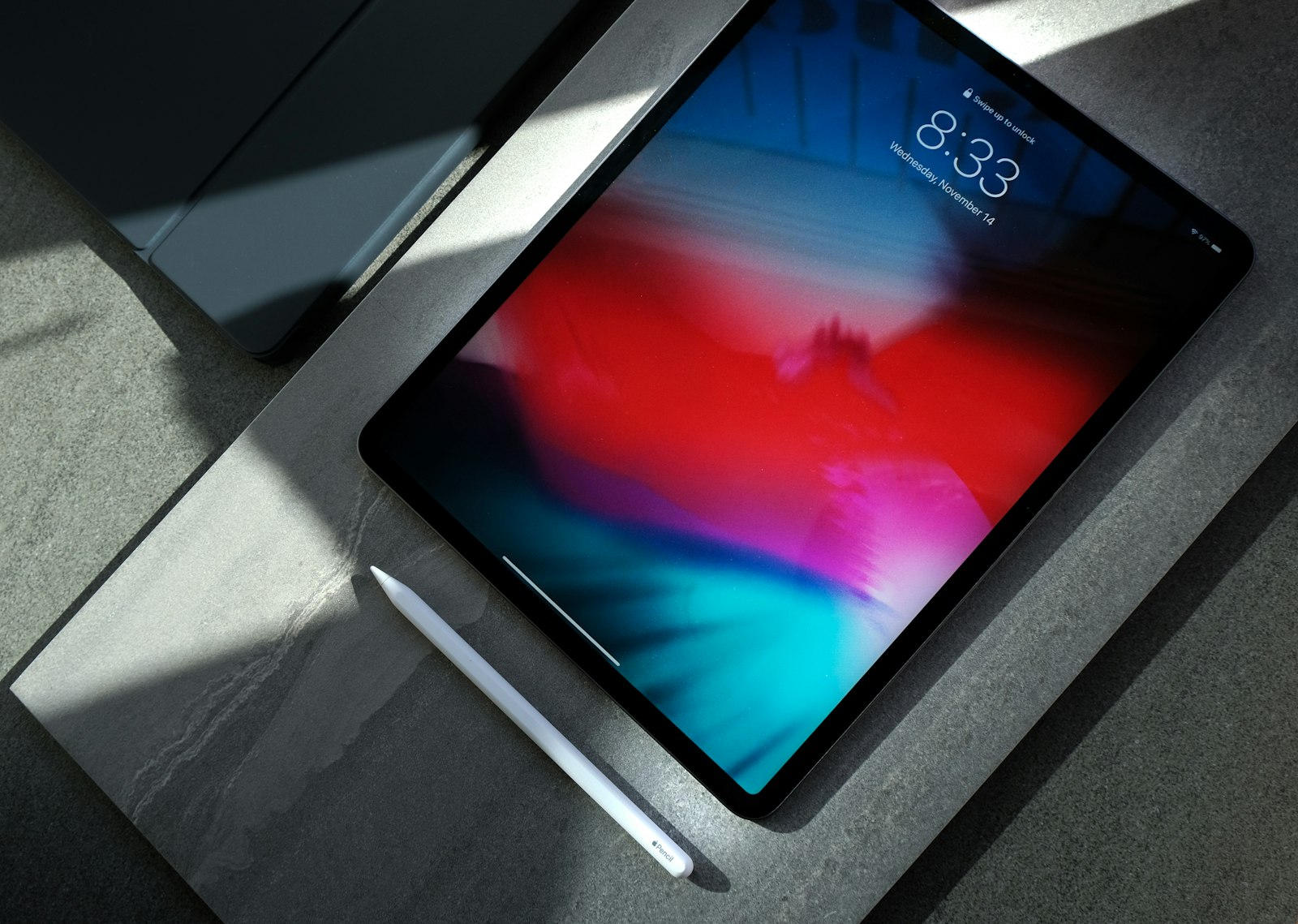 A tablet and stylus on a desk